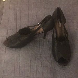 Black open toed closed heeled sandals.